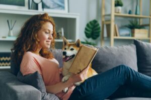 Girl Reading with a Dog